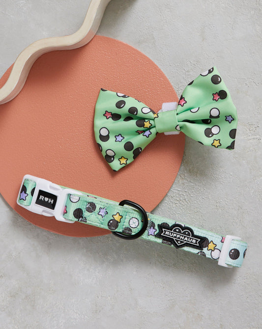 Mint green dog collar and bow tie set with playful star and dot pattern, pet accessories.